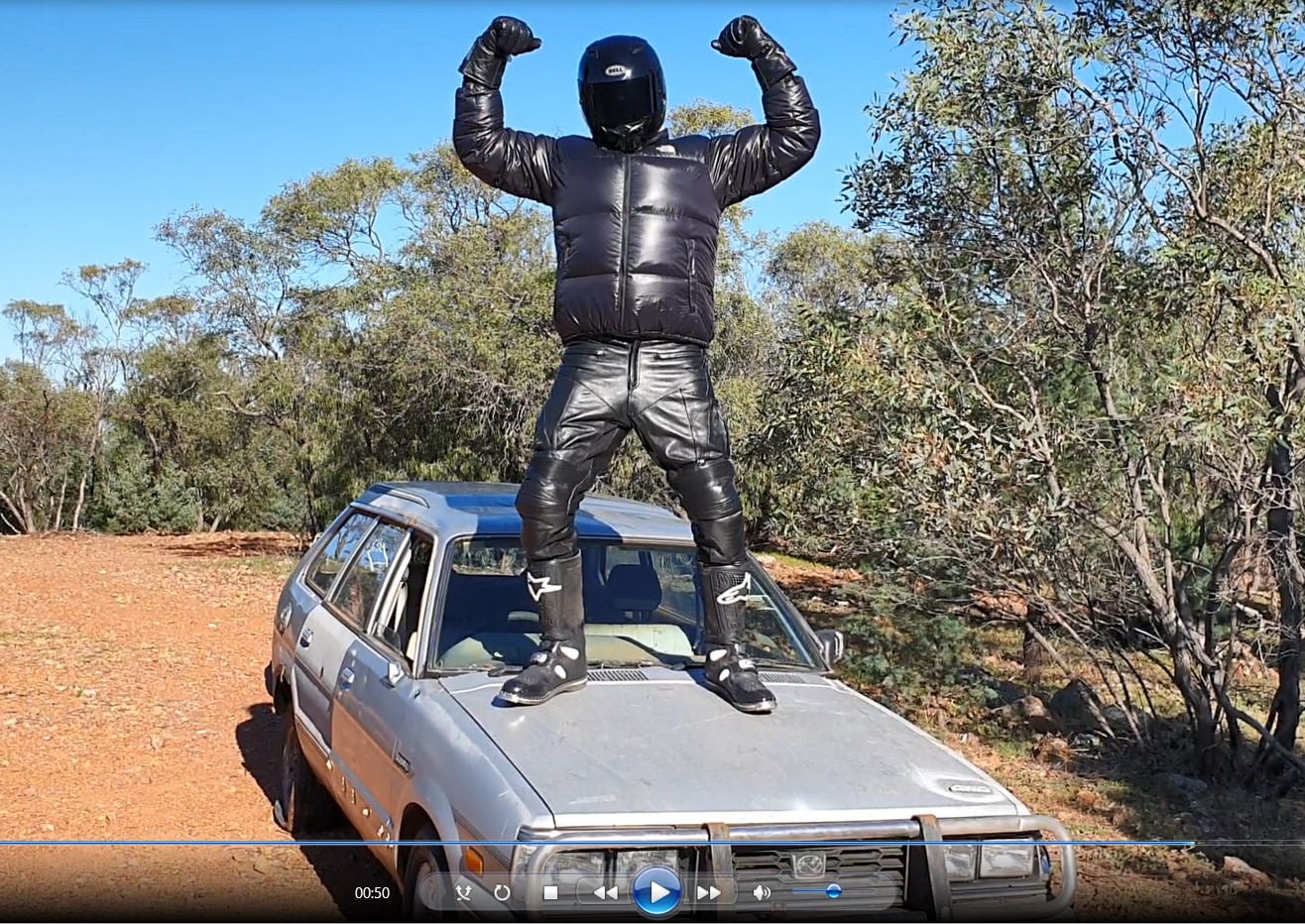 Shiny Helmeted Stomper's boots test a car to be stomped