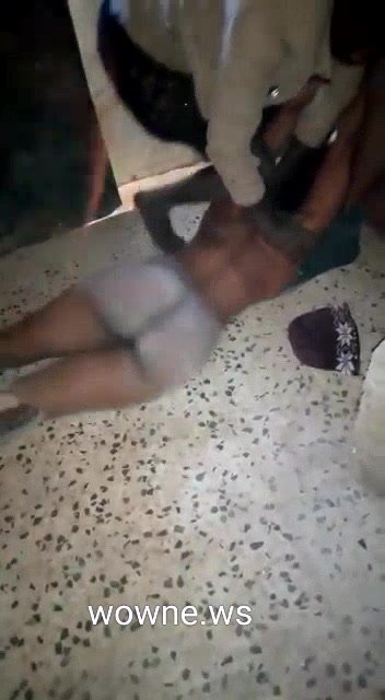Naked African woman beaten