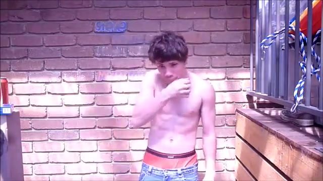 Guy smokes heavily outside without a shirt