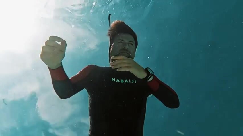 Barefaced wetsuit dad breatholding underwater
