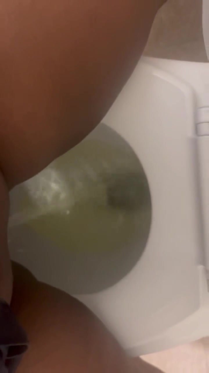 Hydrated ebony films herself hovering over the toilet