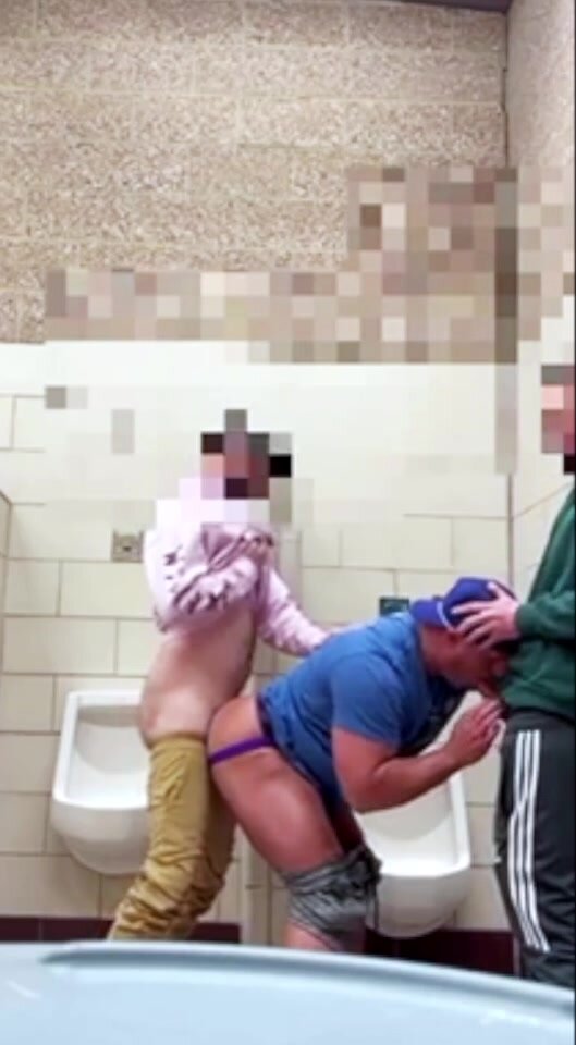 Muscle bottom gets tagteamed in a cruisy restroom