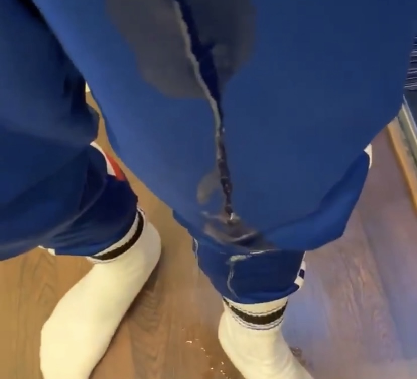 Guy pisses himself in blue adidas sweatpants