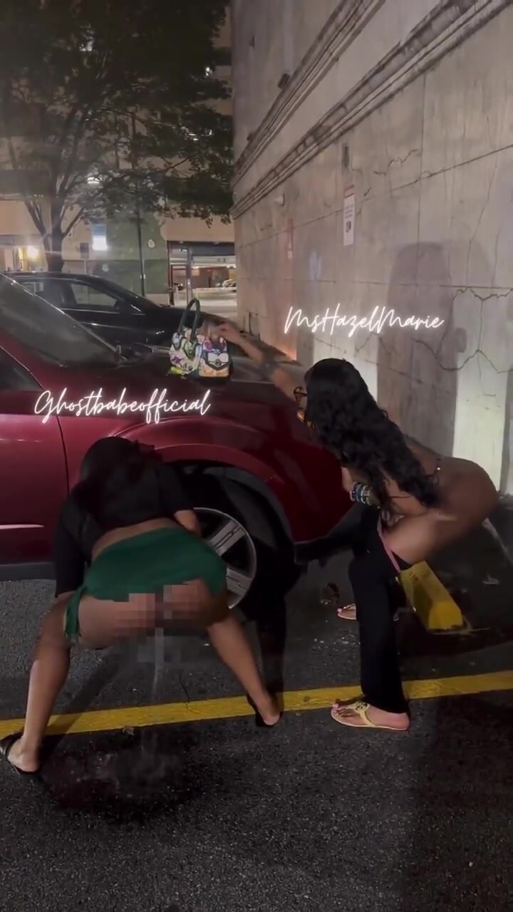 Ebony friends pee in parking lot together
