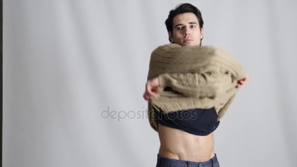 Man takes off his sweater