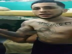 tatted latino thug finger-popping some dude in jail