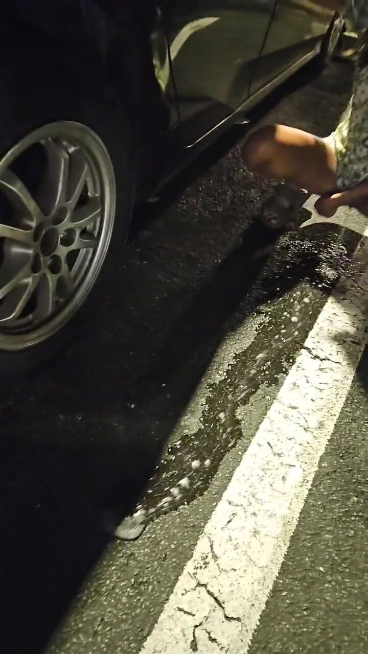 Cute babe floods the parking lot before going inside