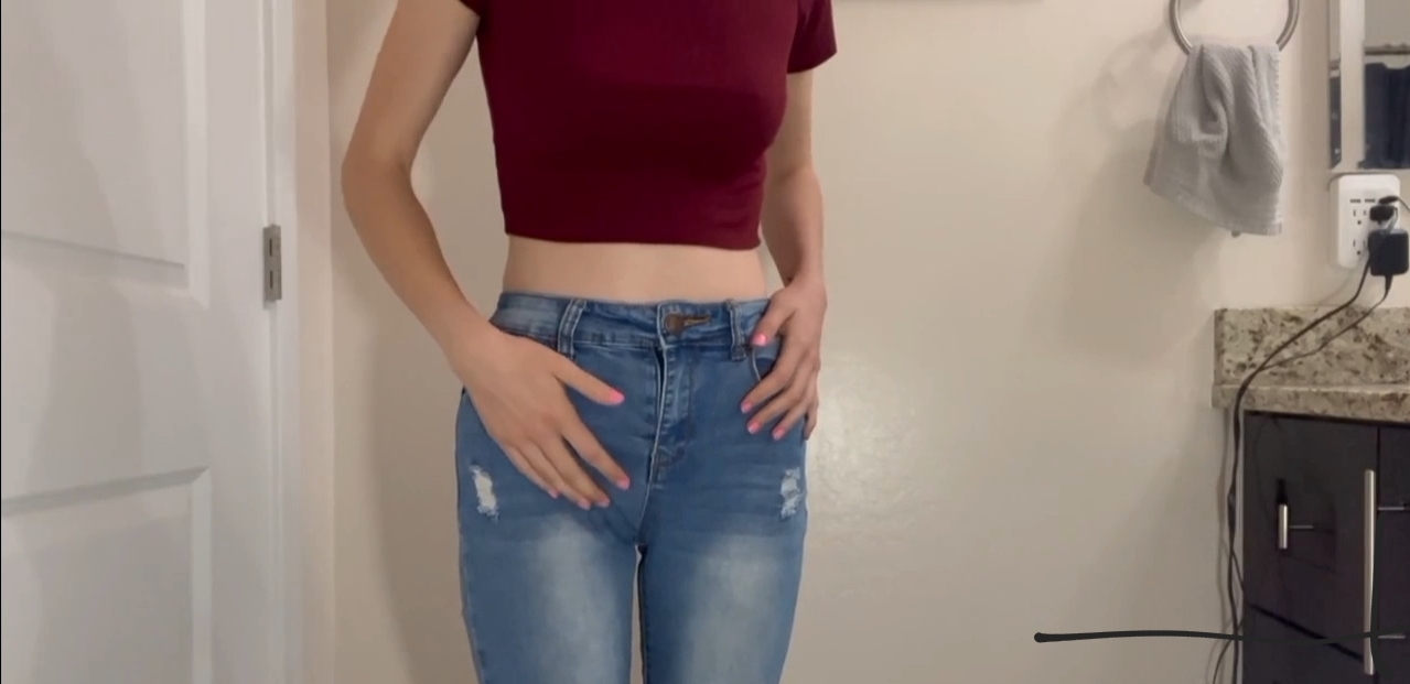 Petite girl wets her jeans