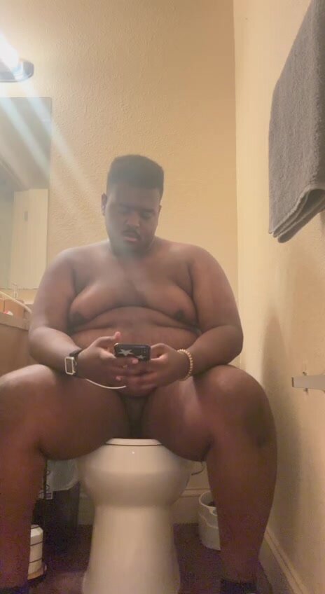Young black chub poops in toilet