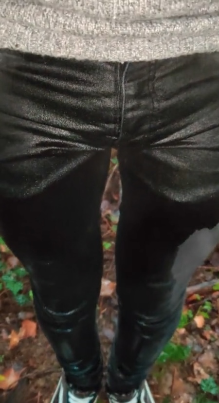 Teen boy wets his pants in the forest