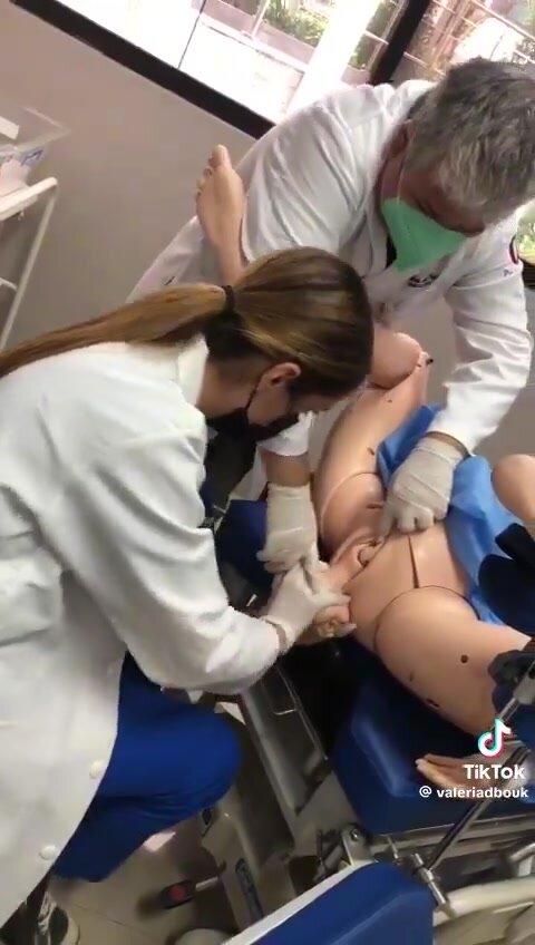 Young latina doctor practices vaginal delivery