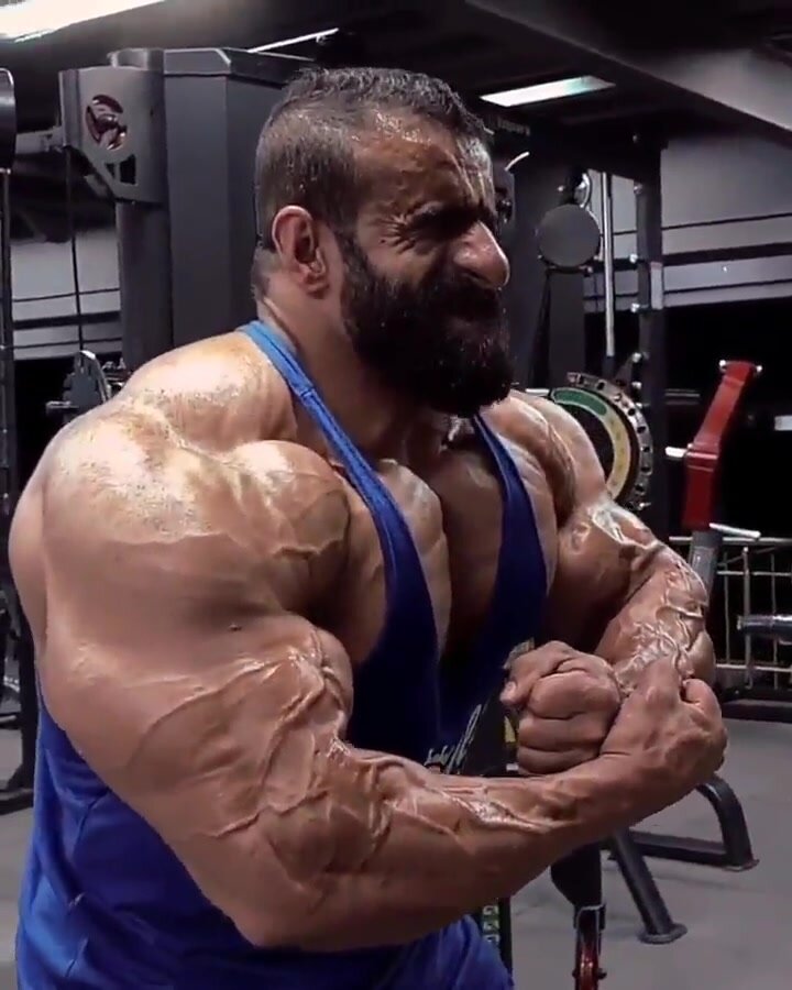 Huge sweaty arab bodybuilder flexing
