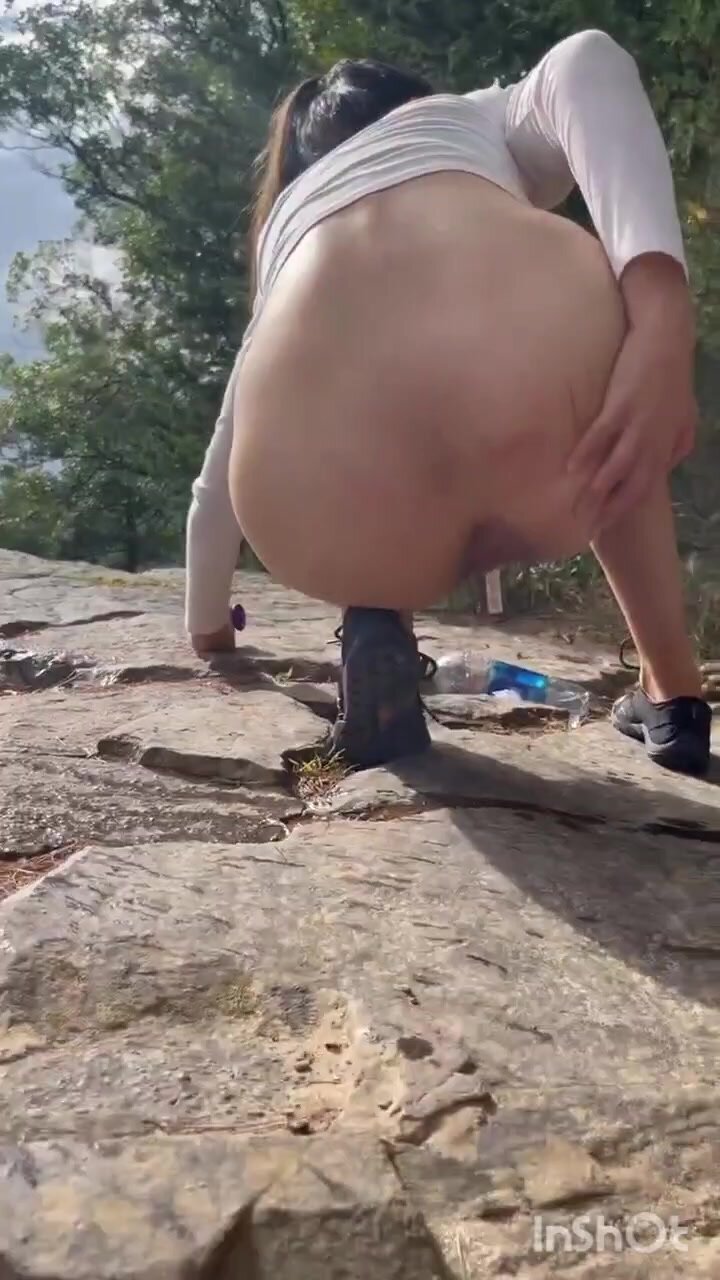 Cute girl outdoor shitting on the rocks