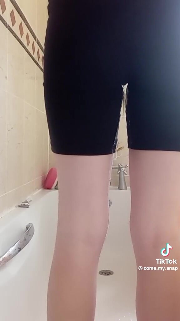 girl wets black shorts