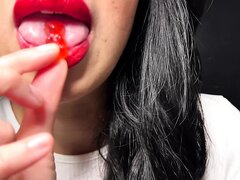 Asian girl big lips chew, mouthplay gummy bears