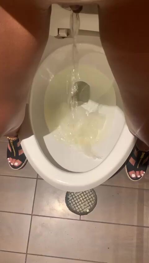 Girl stands over public toilet, pisses, drips & wipes