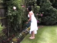Girl pissing in a watering can