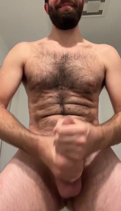 Hairy guy two handed stroke