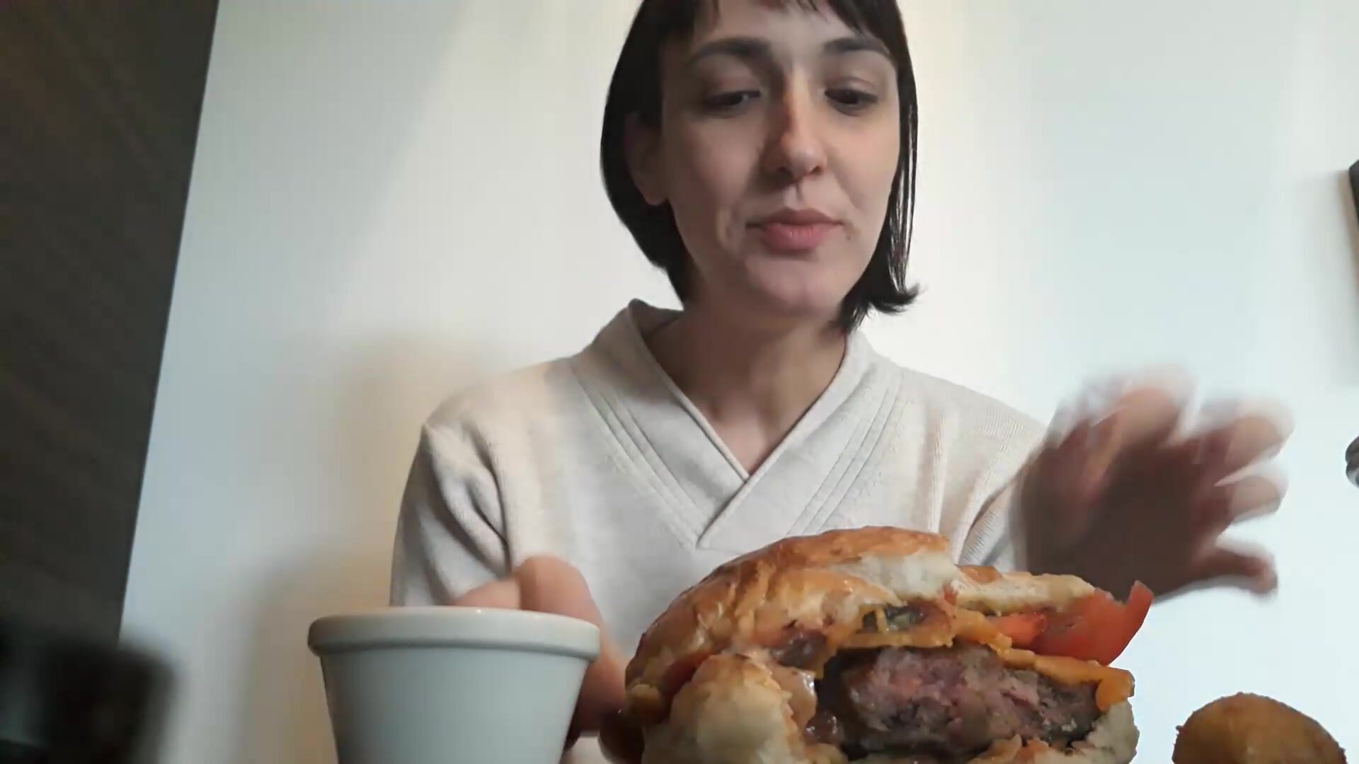 Russian girl eating a cheeseburger in a restaurant
