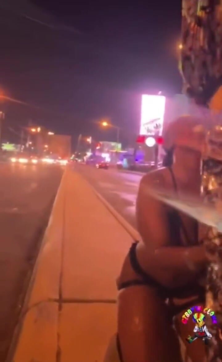 Ebony gets hosed down by a clown on the strip