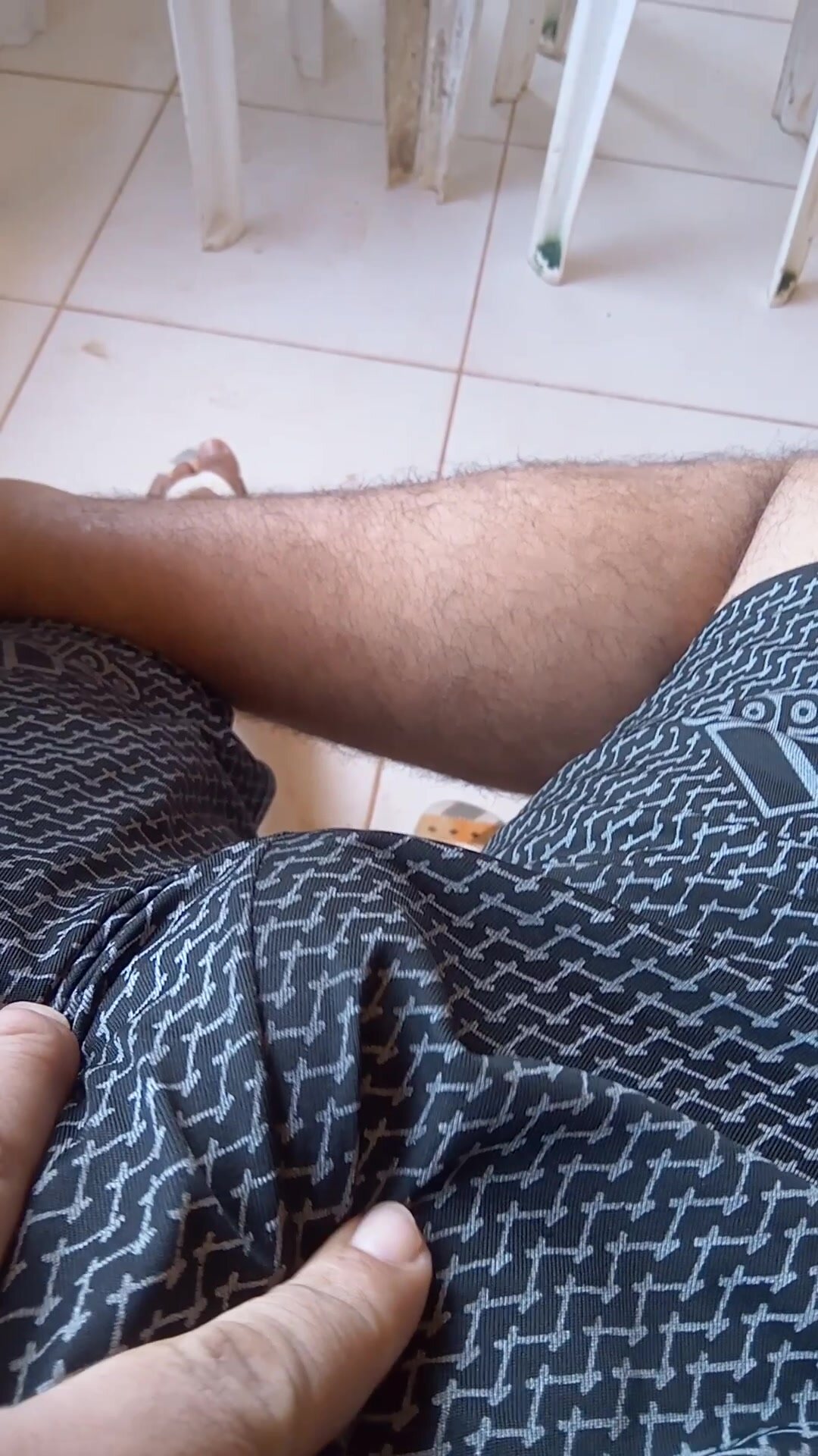 hairy dude rubbing his semi hard dick on his shorts