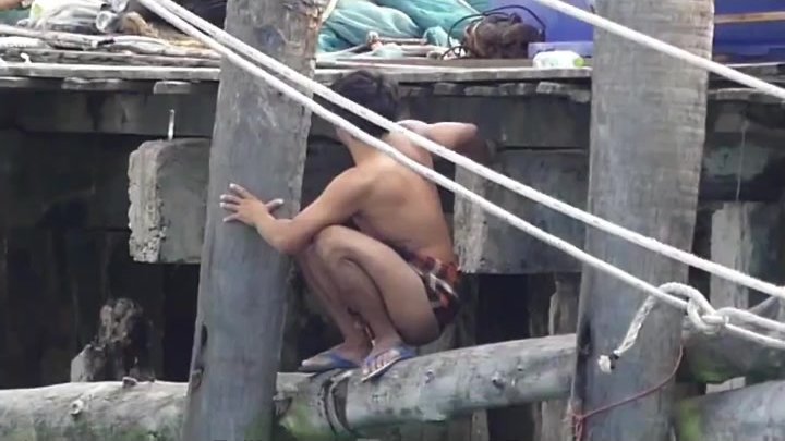 Asian men pissing outdoors