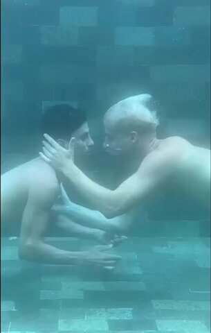 Gay barefaced men kiss underwater