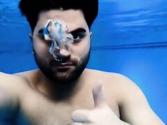 Barefaced arab loosing air underwater in pool