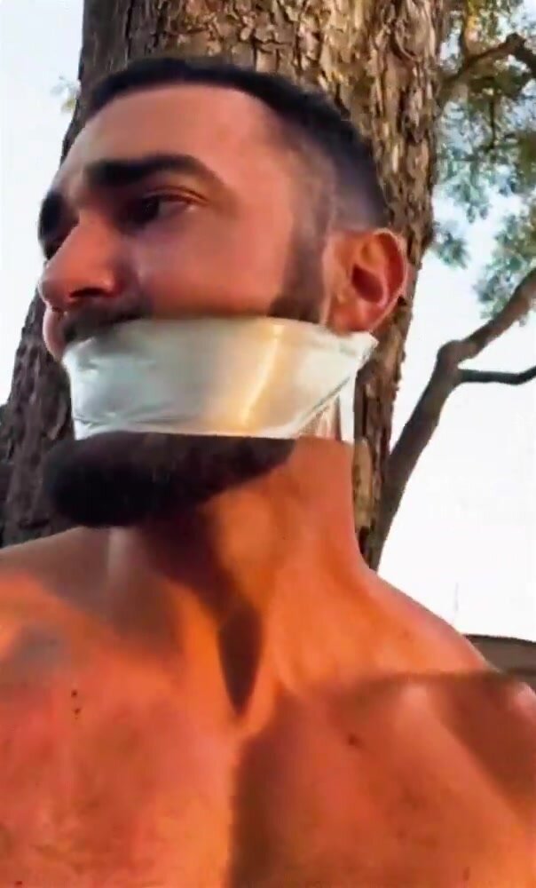 Hot man tied to a tree