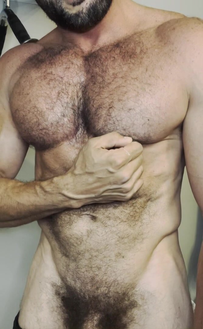 Muscled man showing off hairy body
