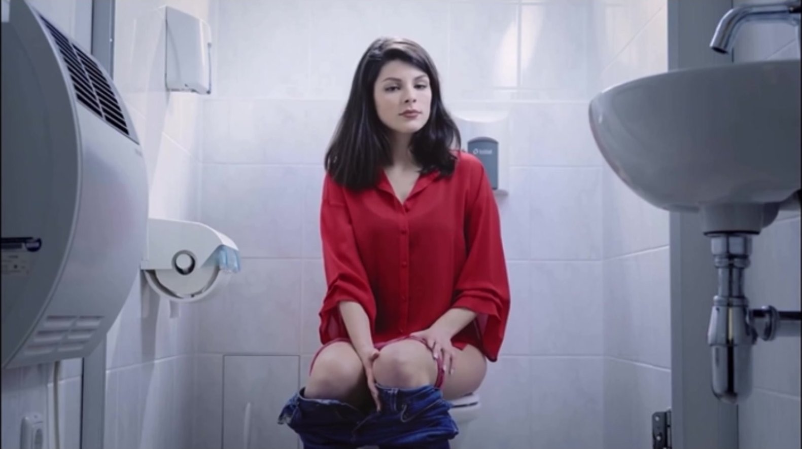 Beautiful girl struggling on the toilet