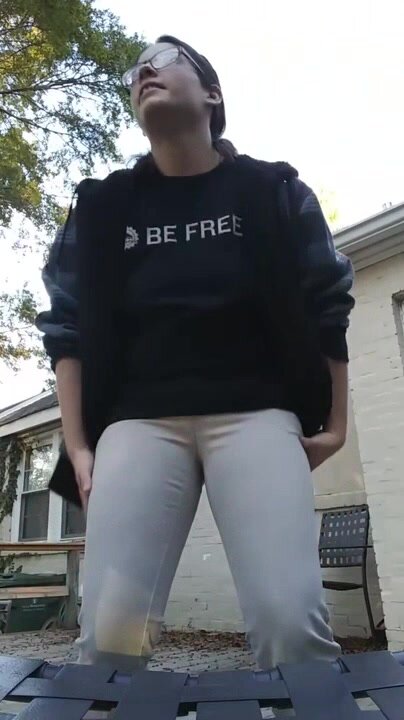 Cute nerdy pees herself outdoor