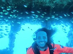 Smiling barefaced cute scubadiver underwater
