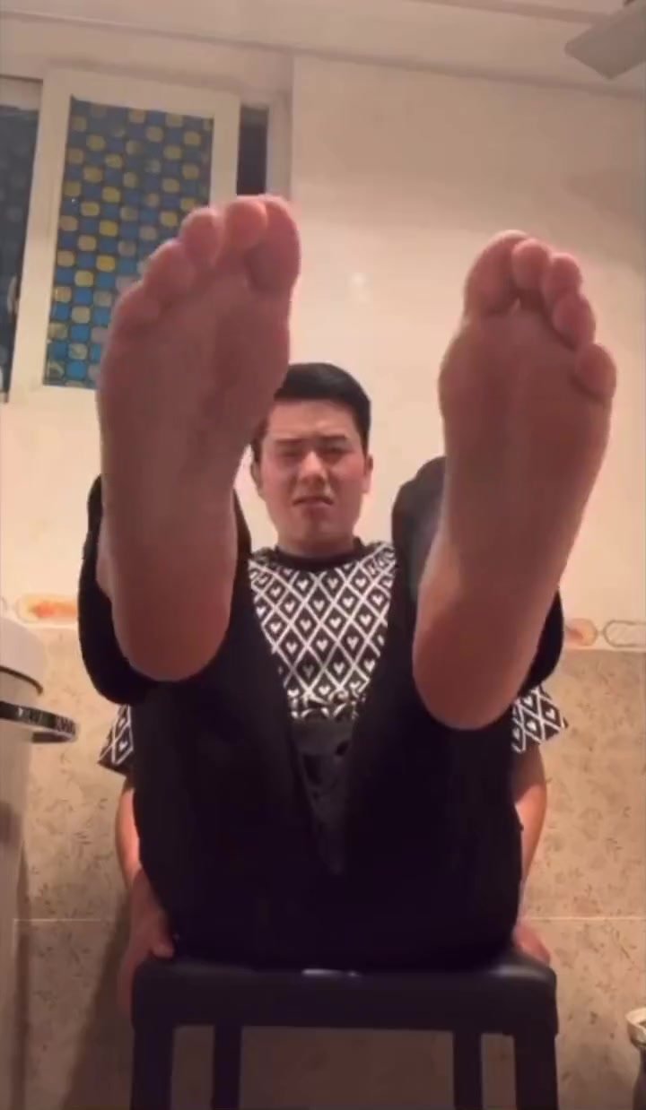 Asian Guy playing with his feet