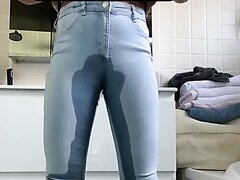 girl pees jeans infront of toilet