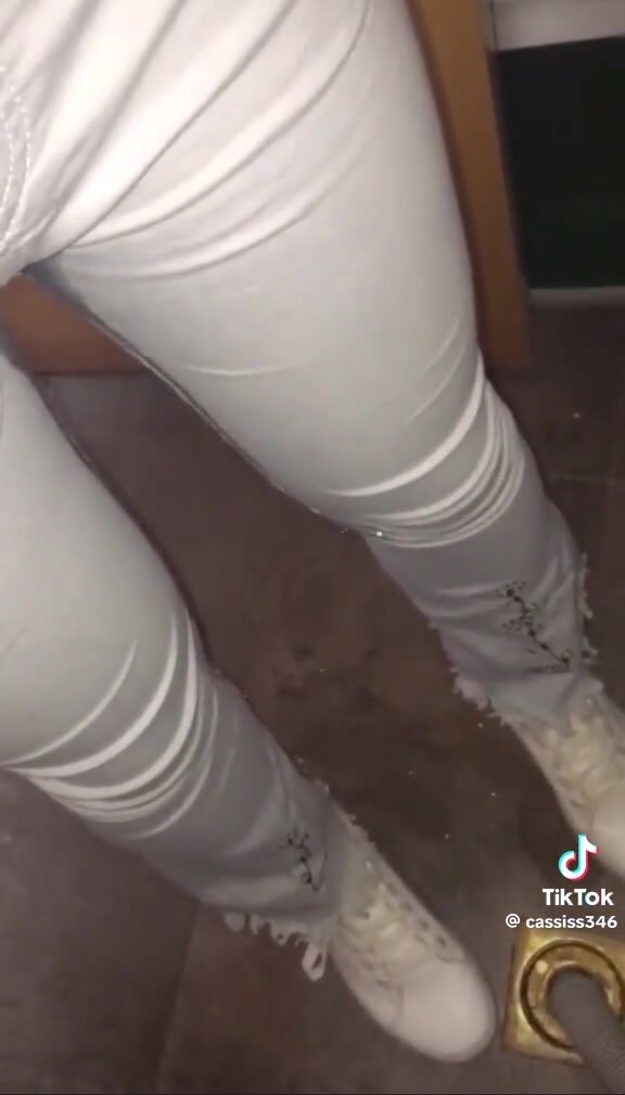 girl pees white jeans