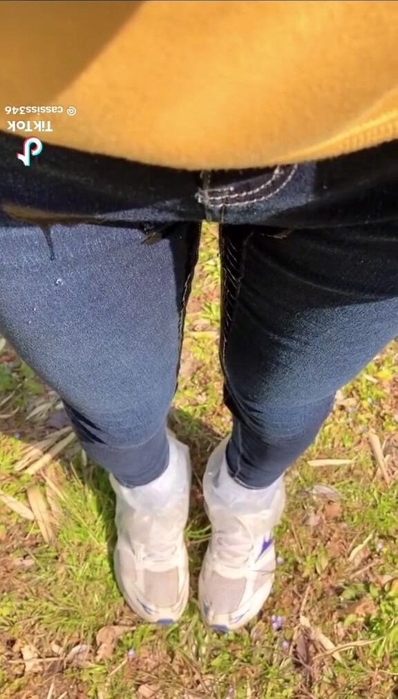 girl pees jeans outside