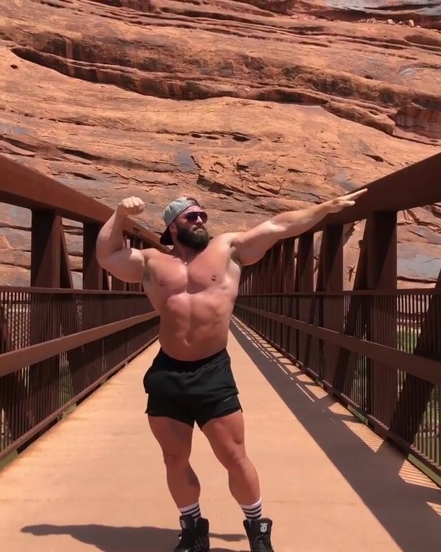 Bodybuilder posing in canyons