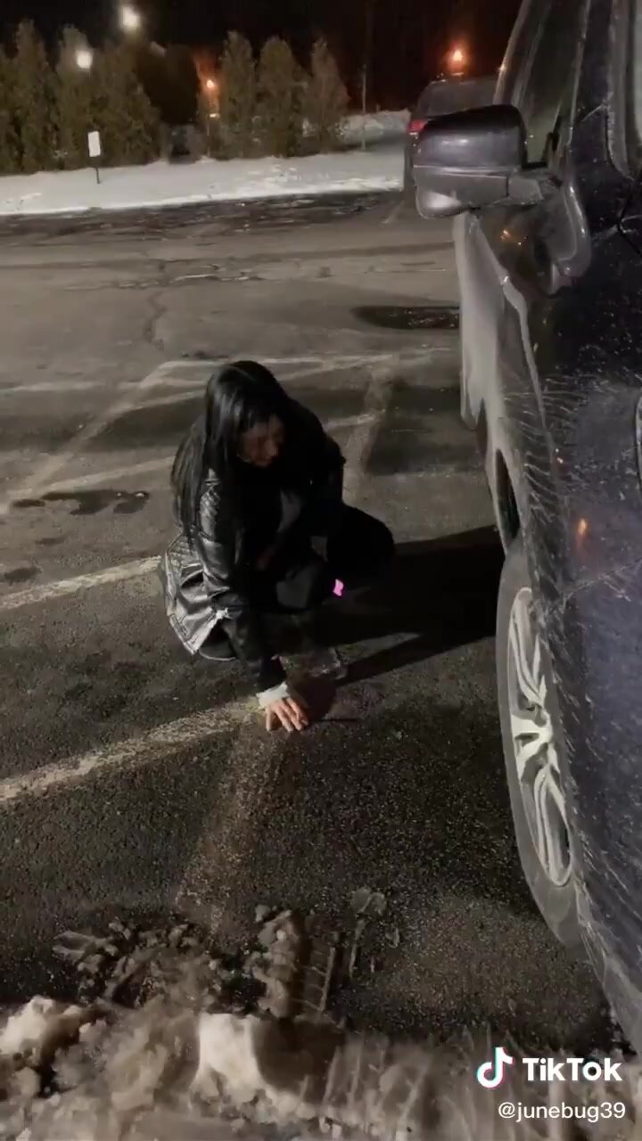 Cute friend streams on the ground next to a truck