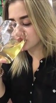 Slut pissing in a cup and drinking her piss