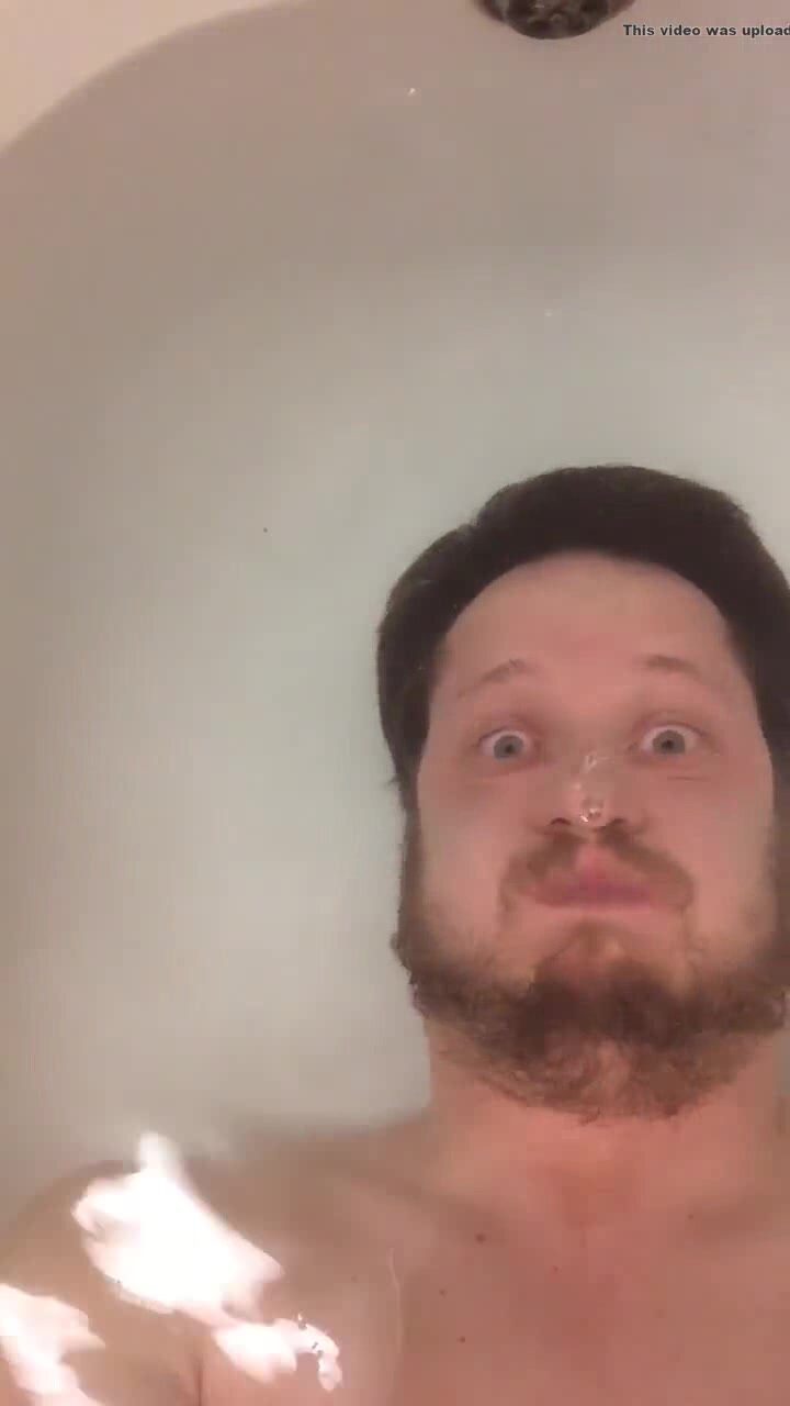Bearded hottie eyes wide open underwater in tub