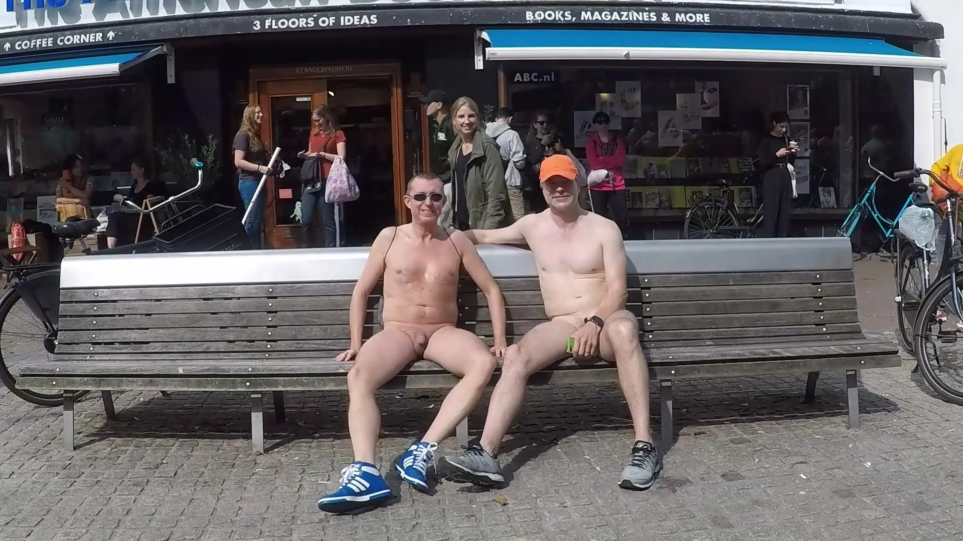 naked men on a street bench