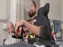 hairy cripple in a wheelchair smokes and jerks off