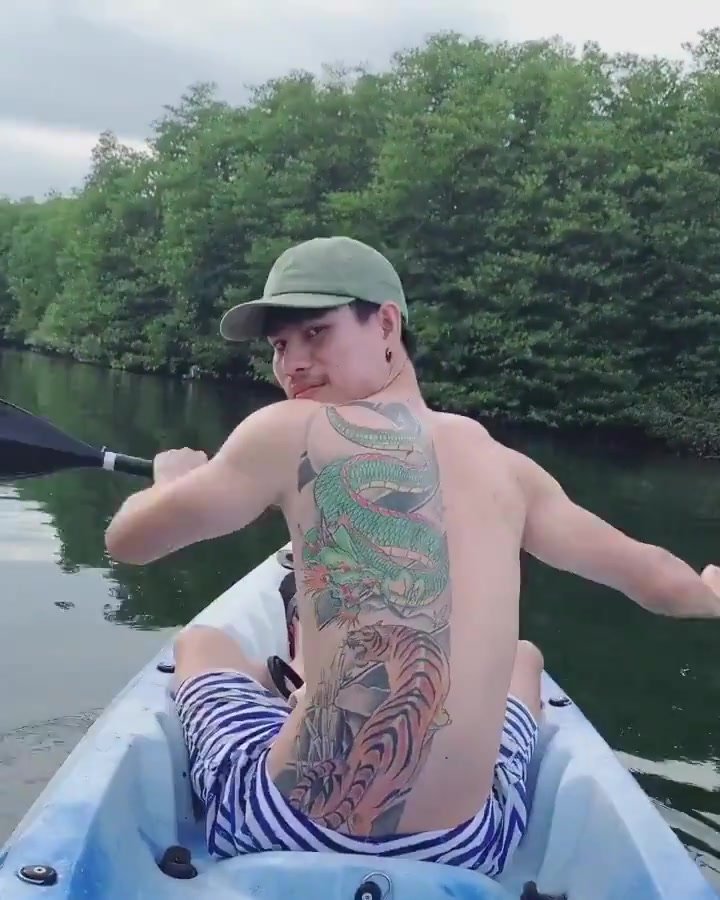 Extremely beautiful and muscular boy in a canoe