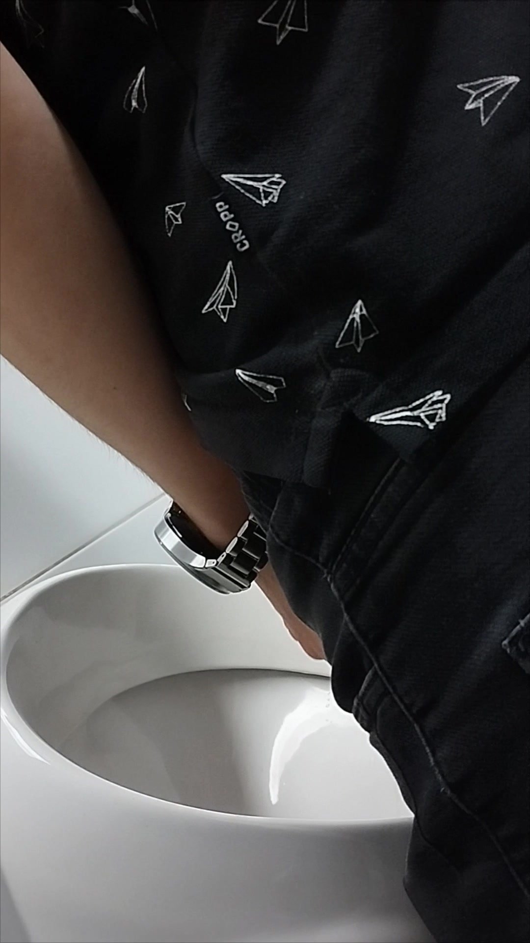 Two guys pissing at the urinals