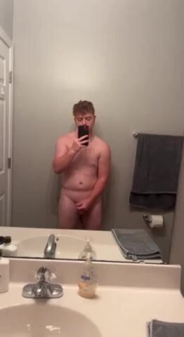 stocky ginger stroking  in bathroom