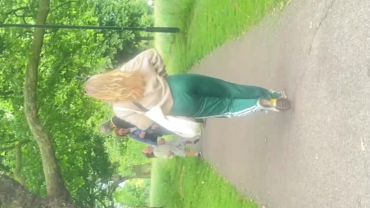 Blonde walking in green tracksuit pants
