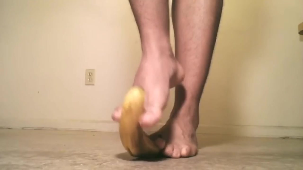 Male feet crush banana