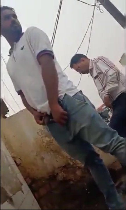 Handsome Indian in public urinal