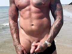 British alpha master pees on public beach